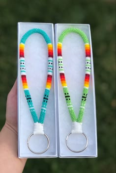 two keychains with beads are in a box