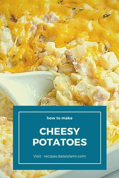 cheesy potatoes in a white casserole dish with a spoon on it