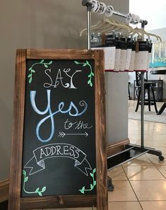 a chalkboard sign with the words yes to the address written in cursive writing