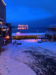 there is a sign that says public market on the side of this street in winter