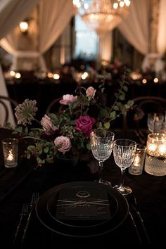 the table is set with candles and flowers