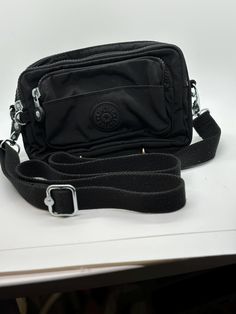 Convertible Kipling crossbody bag black.  3 outside zippered pockets.  8"L X 5 1/2"W X 1"D.  100% polyemide outside.  100% polyester inside. Black Crossbody Bag With Zipper Pouch, Functional Black Shoulder Bag With Zipper Pouch, Kipling Crossbody Bag, Best Self Help Books, Convertible Crossbody Bag, Crossbody Bag Black, Sling Bags, Black Cross Body Bag, Wedding Shop