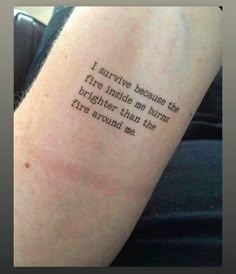 a person with a tattoo on their arm saying i survive because the fire inside me burns brighter than the fire around me