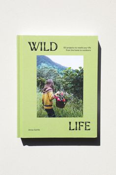 a book with the title wild life written in black on it and a photo of a child holding flowers