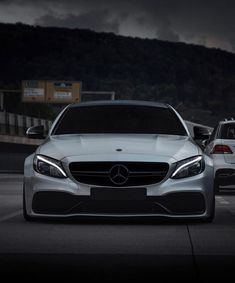 the front end of a white mercedes car