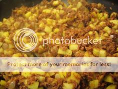 potatoes and meat cooking in a pan with the words photobucket written below it