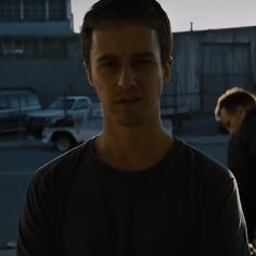 a man standing in the middle of a parking lot