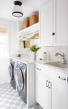 a washer and dryer in a white laundry room