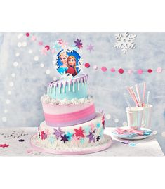 a frozen princess birthday cake with frosting and icing on the top, surrounded by confetti sticks