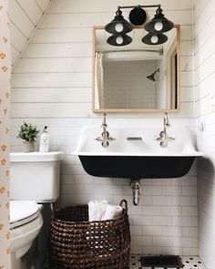 a bathroom with a sink, mirror and toilet