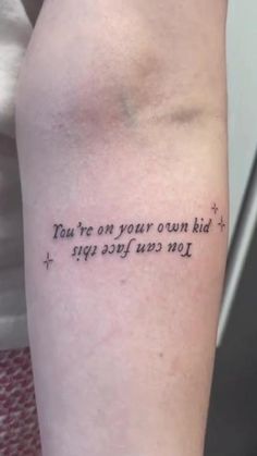 a person with a tattoo on their arm saying you're on your own kid