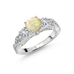 a white gold ring with an opal and diamonds