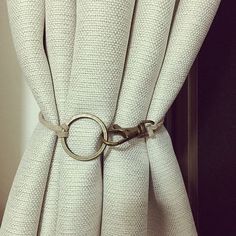 a curtain with a metal ring hanging from it's side