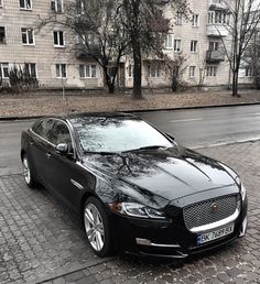 a black car parked in front of a building