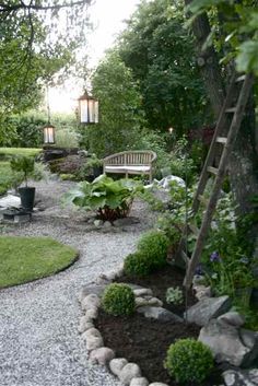 a garden with gravel, rocks and plants