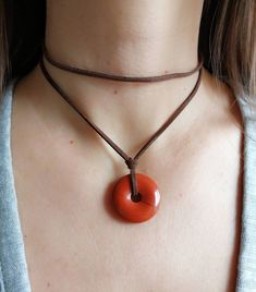 Red jasper pendant necklace; gift for woman; layered tan suede necklace -genuine red jasper gemstone pendant;  -stainless steel (non tarnish) claps closure -faux suede leather cord -ready to give as a gift, this necklace comes wrapped in a nice jewelry pouch. Please measure the neck circumference before order then select the correct size. Size is related to the upper layer of the necklace (the short layer)  Please notice that the pictures are suggestive and the original necklace may vary slightl Adjustable Gemstone Choker Necklace, Adjustable Natural Stone Choker Necklace, Brown Pendant Jewelry With Adjustable Cord, Gift Choker Necklace With Adjustable Length, Adjustable Choker Jewelry Gift, Adjustable Length Choker Necklace For Gift, Adjustable Length Choker As A Gift, Carnelian Gemstone Beads Jewelry Gift, Adjustable Agate Jewelry For Gifts