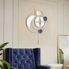 a living room with a blue chair and a clock on the wall above it's head