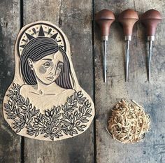 an image of a woman with flowers in her hair next to some wood carving tools