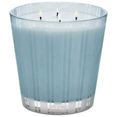 a blue glass candle holder with three candles in the middle and one lit on top