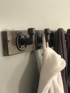 towels are hanging on the clothes rack in this bathroom, and there is also a towel holder