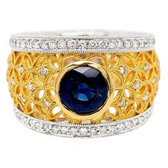 Produced by award winning Italian designer Stefano Vitolo. Stefano creates custom artisanal one of a kind jewelry with excellent gemstones in a truly old world Italian craftmanship. This handcrafted ring has .81 total carat weight of F/G color and VS clarity diamonds. Blue Sapphire Center Stone 1.60 carat. Band width 10-14 mm. Available also in 18 Karat Yellow, White or Pink on request. Luxury Gold Sapphire Fusion Ring, Luxury Sapphire Gemstones With Accent Stones, Luxury Multi-stone Sapphire Jewelry, Elegant Wide Band Gemstone Jewelry, Unique Yellow Gold Sapphire Ring With Accent Stones, Luxury Round Ruby Ring, Artisan Jewelry With Intricate Design For Anniversary, Luxury Sapphire Jewelry With Accent Stones, Luxury Collectible Sapphire Ring With Center Stone