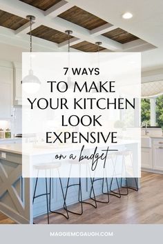 an open kitchen with white cabinets and wood floors, the words 7 ways to make your kitchen look expensive on a budget