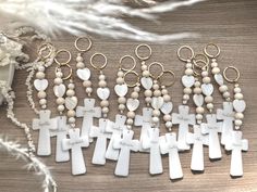 cross keychains with beads and charms on a table