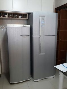 two silver refrigerators side by side in a kitchen