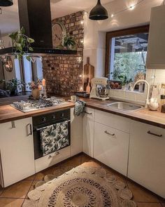 a kitchen with an oven, sink and stove top in the middle of the room