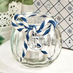 a clear glass jar with blue and white rope around it