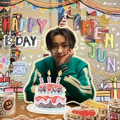 a boy sitting at a table with a birthday cake