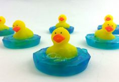 several rubber ducks floating in blue and yellow water