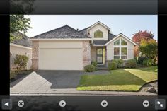 a large house with two garages in the front yard