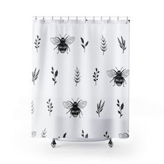 a shower curtain with black and white bees on it