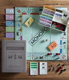 the monopoly board game is on display with its contents and pieces laid out around it