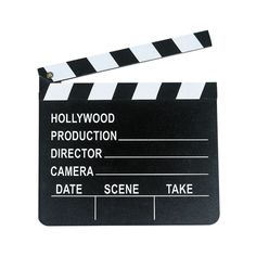 a movie clapper sitting on top of a white table next to a black and white sign