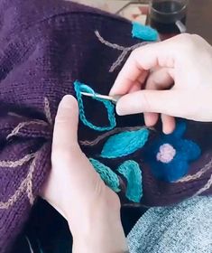 someone is knitting something with yarn and scissors