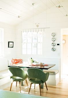 the dining room table is set with four chairs