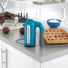 a kitchen counter with an electric hand mixer on top of it next to a pie