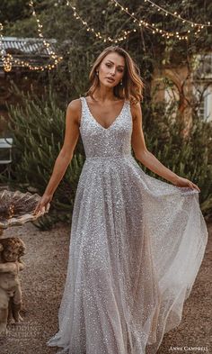 a woman in a white dress is standing outside