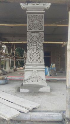 a tall white clock sitting in the middle of a building