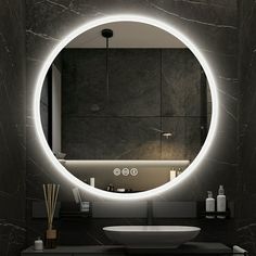 a bathroom with a round mirror above the sink and lights on the wall behind it