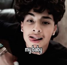 a young man with curly hair holding a toothbrush