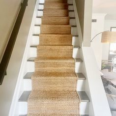 a carpeted staircase leading up to the second floor