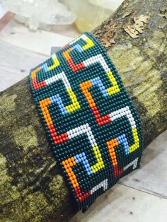 a beaded bracelet on top of a tree branch