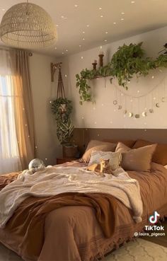 a large bed sitting next to a window in a room with plants on the wall