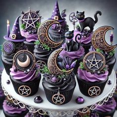 there are cupcakes decorated with witches and moon decorations on top of the cake