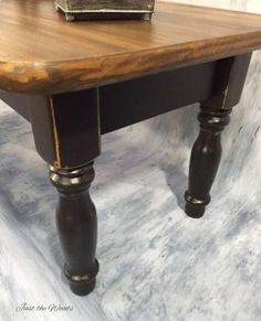 a wooden table sitting on top of a white floor