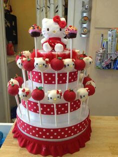 a hello kitty cake with red and white decorations