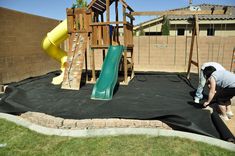 a man working on a play area in the backyard